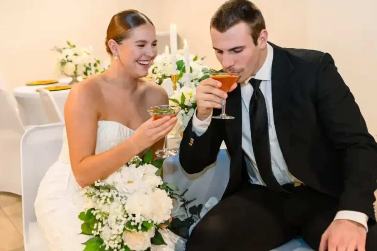 Bars on Wheels bride and groom sipping cocktails at elegant wedding reception bar setup