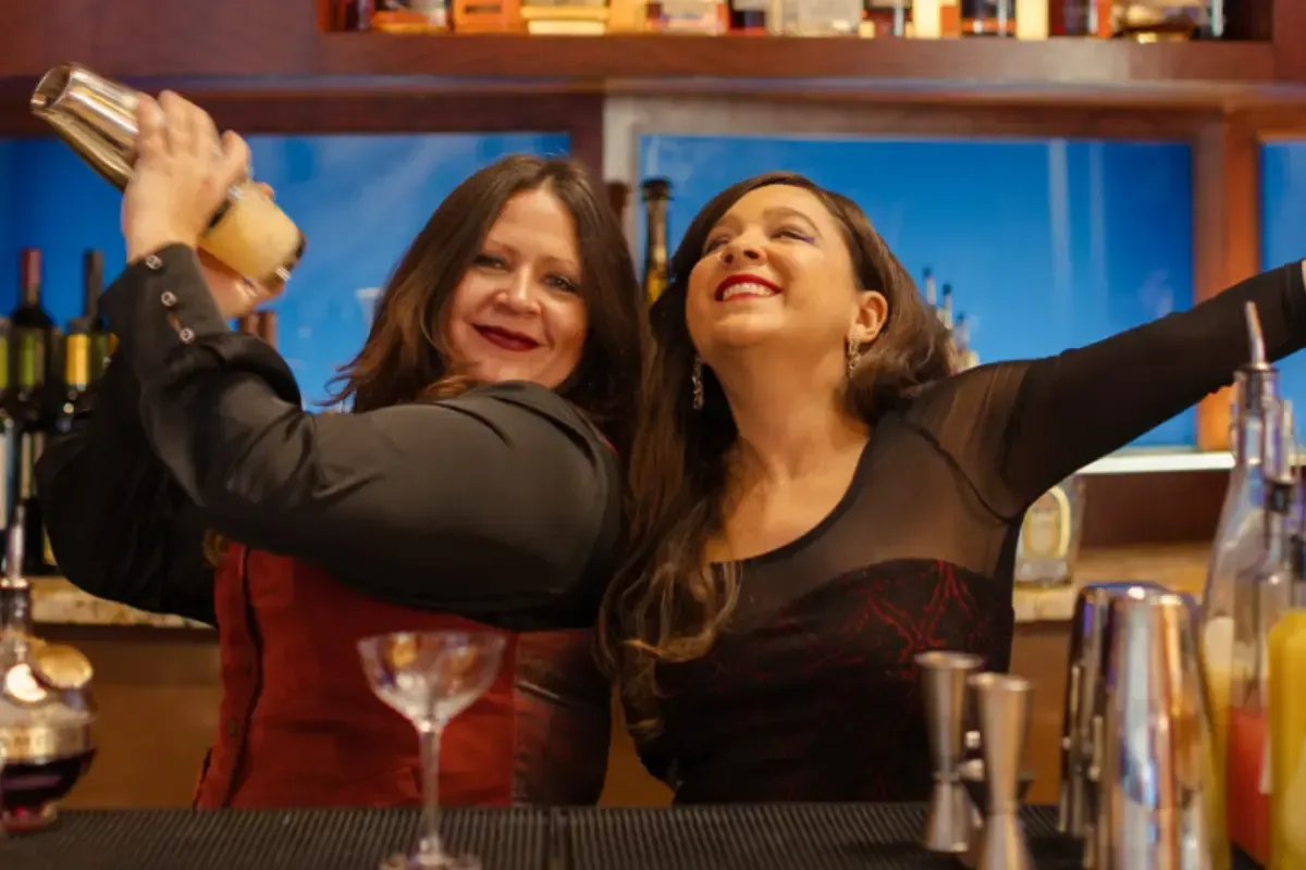 Bars on Wheels bartenders shaking cocktails while entertaining guests at energetic private party bar setup