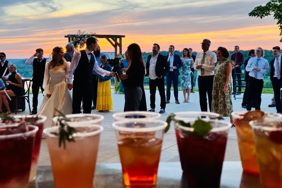 Bars on Wheels outdoor wedding guests enjoying cocktails served from mobile bar during sunset celebration