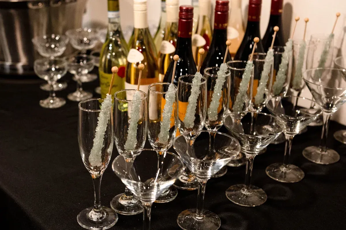 Bars on Wheels cocktail glassware arranged with garnishes at elegant event drink station setup