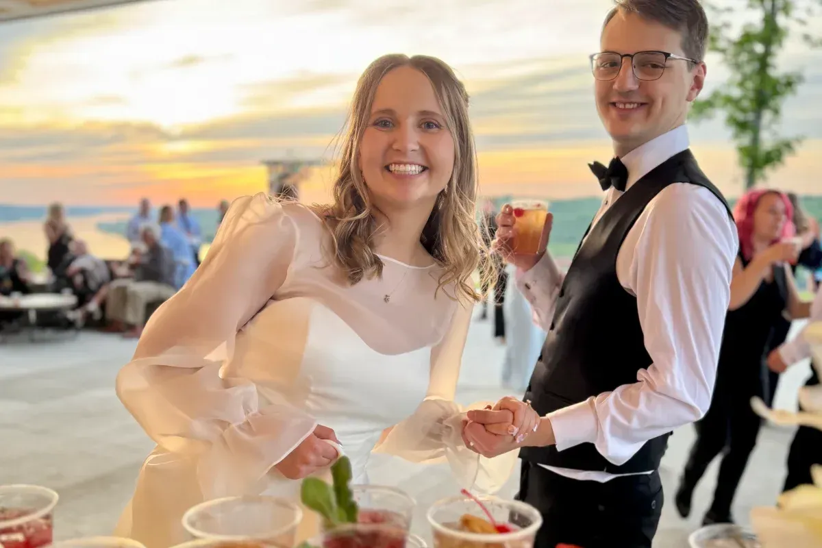 Bars on Wheels smiling wedding couple enjoying cocktails at outdoor reception with mobile bar se