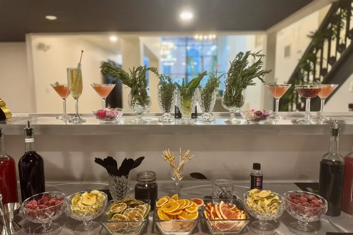 Bars on Wheels cocktail bar setup with fresh garnishes and drinks displayed at elegant private event