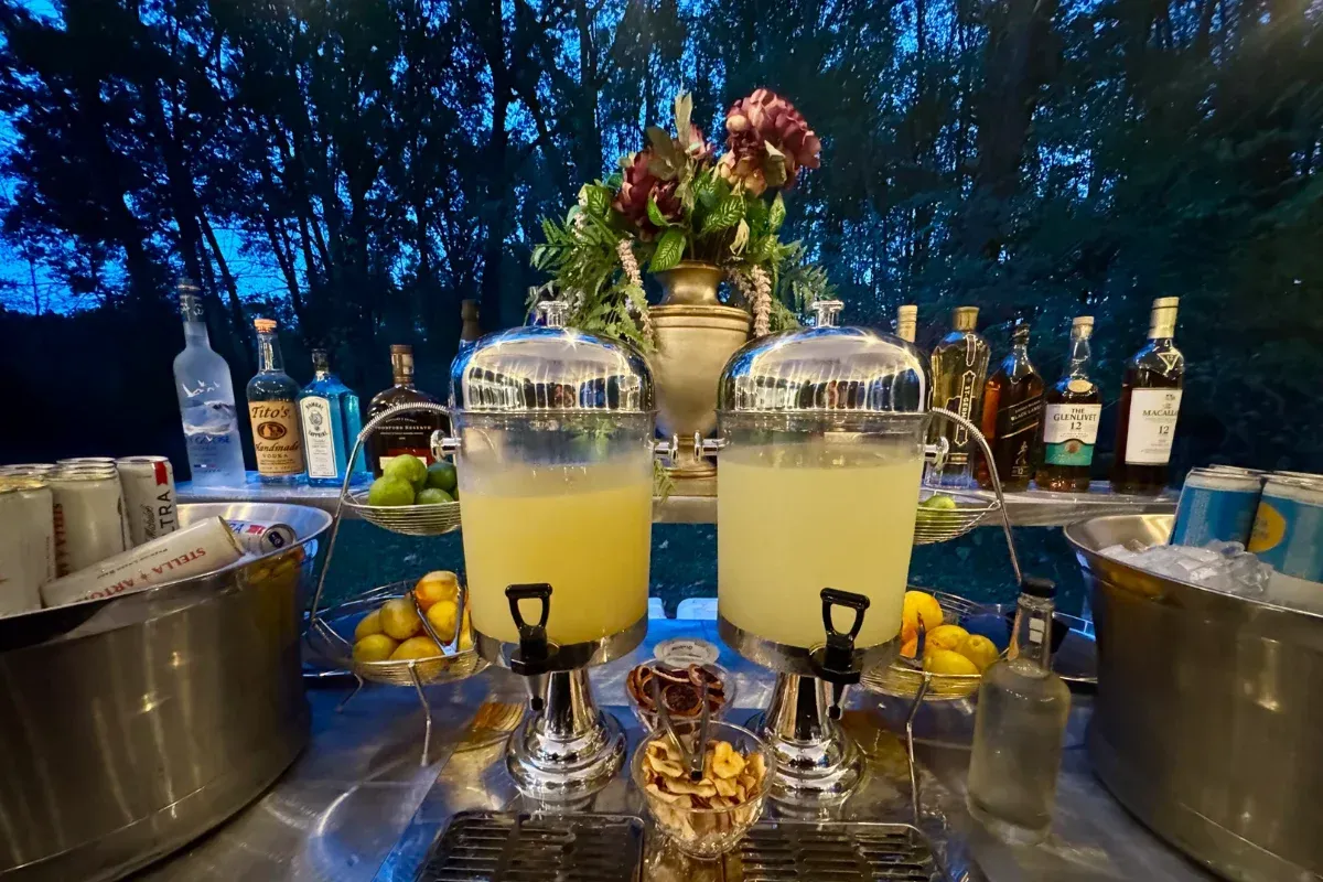 Bars on Wheels outdoor drink station with beverage dispensers and liquor display at private event setup