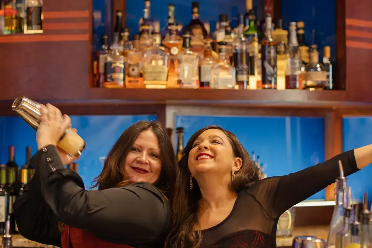 Bars on Wheels bartenders mixing drinks while engaging guests at lively private party bar setup