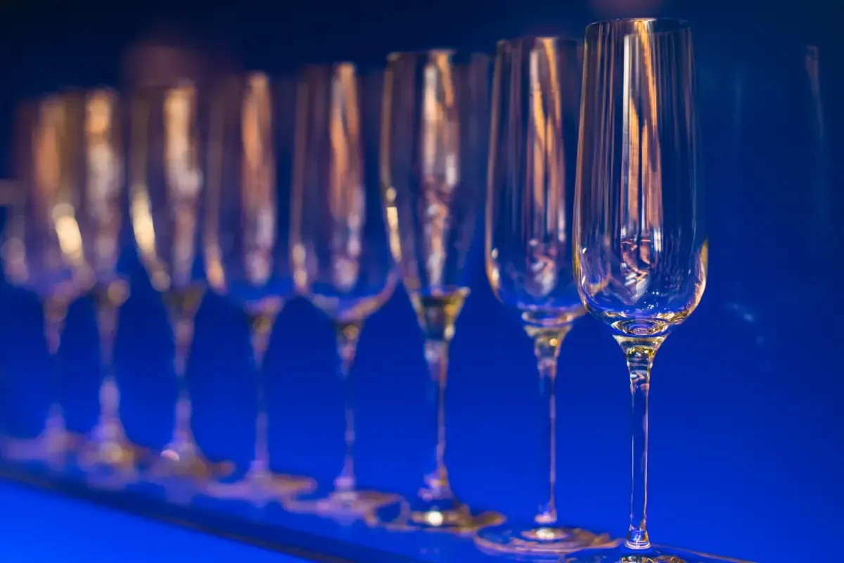 Bars on Wheels elegant champagne glasses lined up on illuminated mobile bar setup