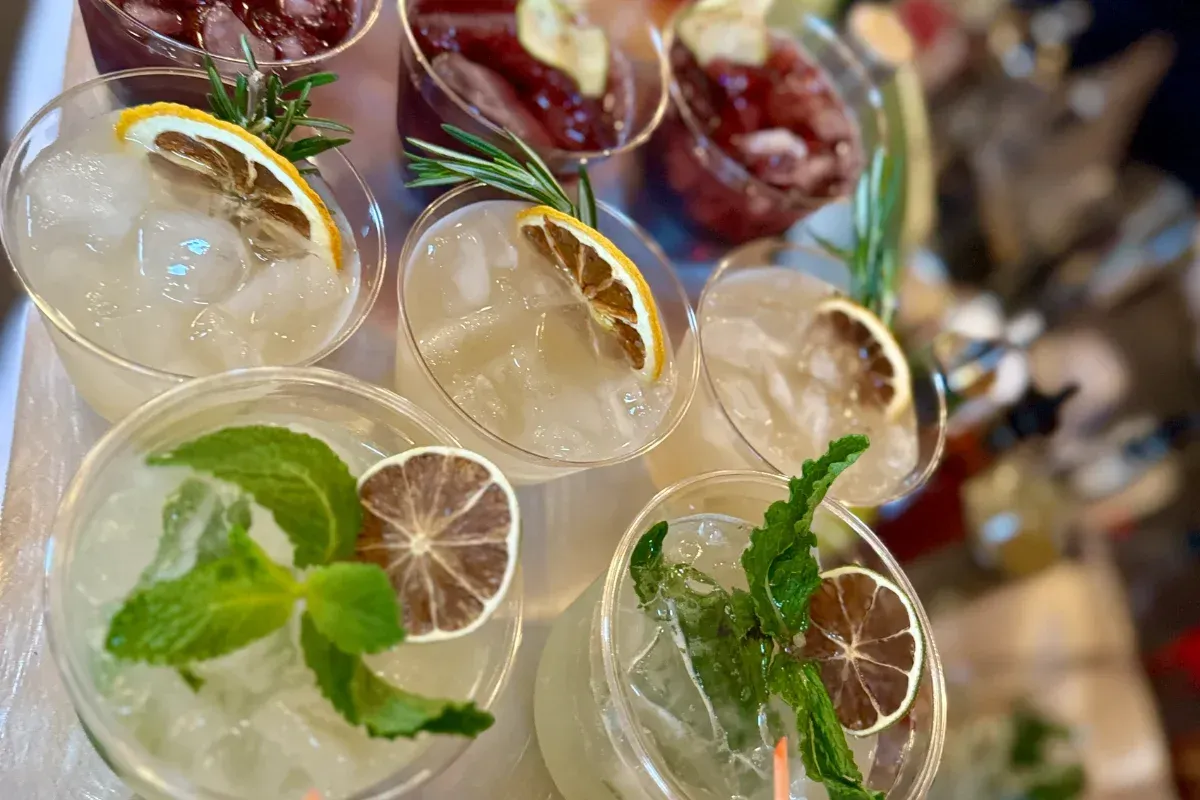 Bars on Wheels cocktail bar setup with fresh garnishes and drinks displayed at elegant private event
