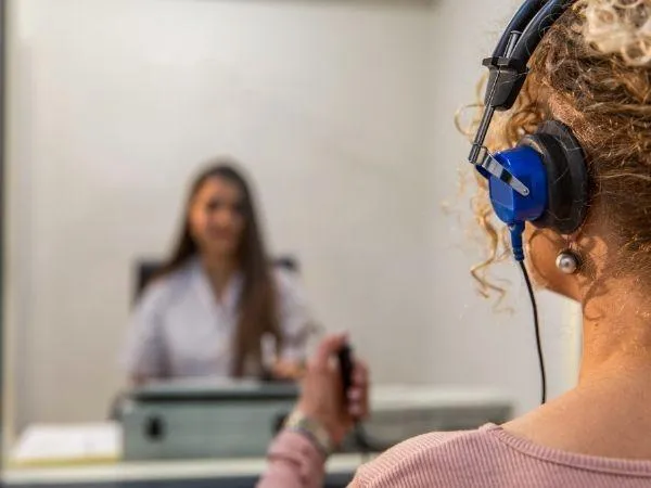 a woman is putting on a pair of glasses