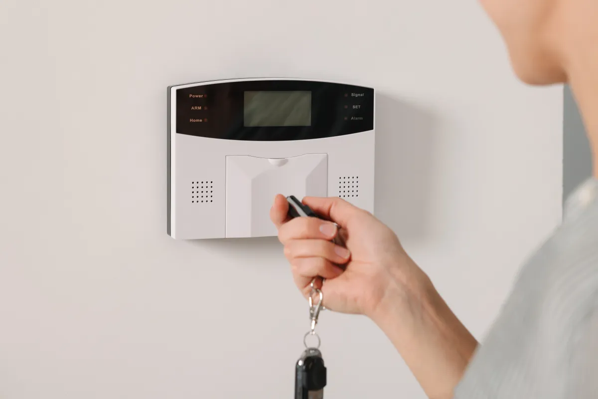 Home Security System. Woman Using Alarm Key Fob, Closeup