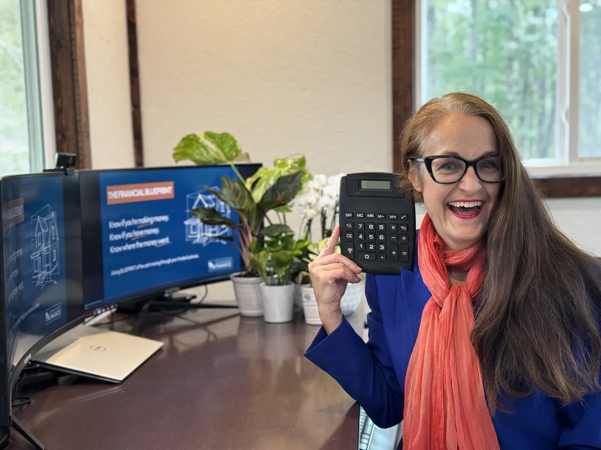 Smiling while holding a calculator for the metals distributor case study.