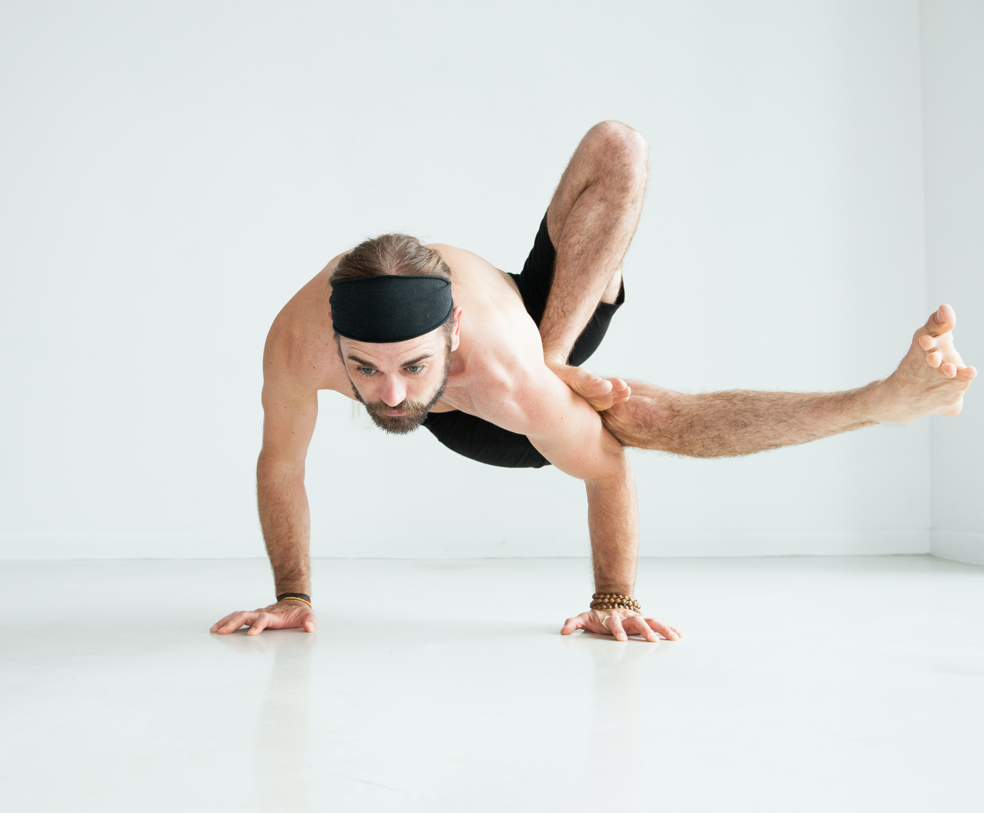 Yoga practitioner in an arm balance pose indoors