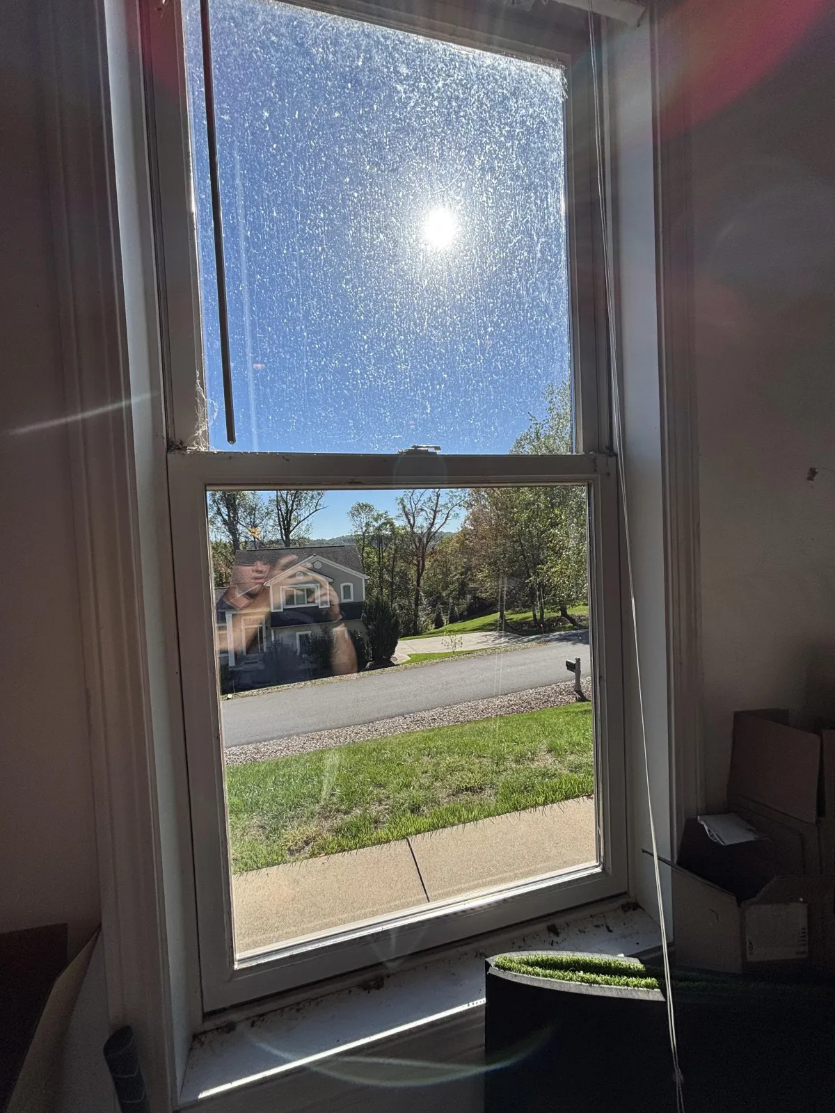Sunlight shining through a wet window pane.