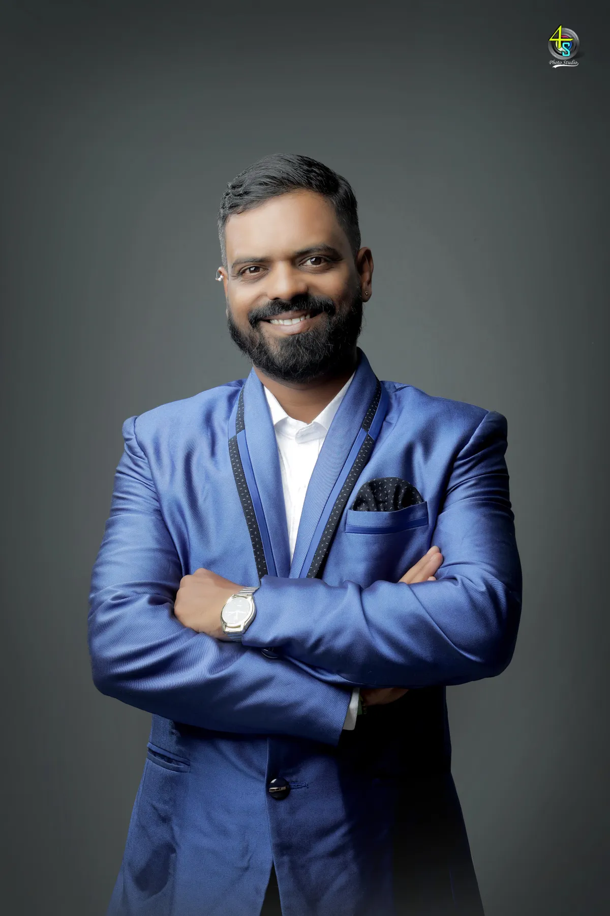 Professional head-and-shoulders portrait of an Indian woman in her thirties, smiling, in business clothing, against a LIGHT softly blurred background