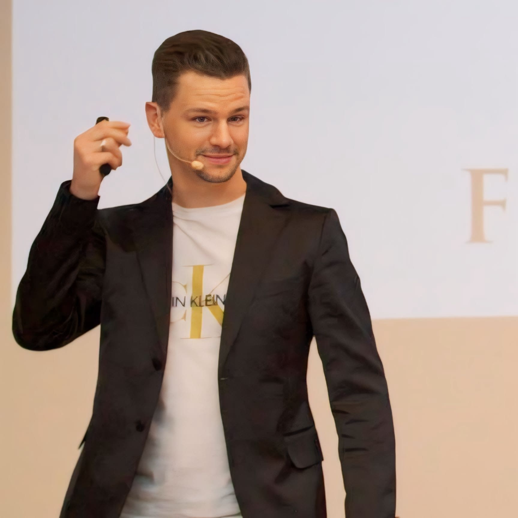 man standing on stone looking at sunset