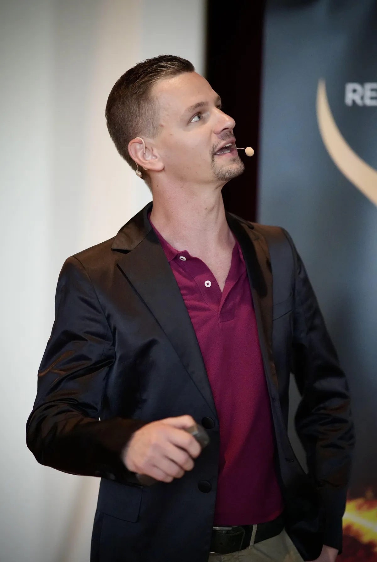 man in blue denim top standing under tree leaf