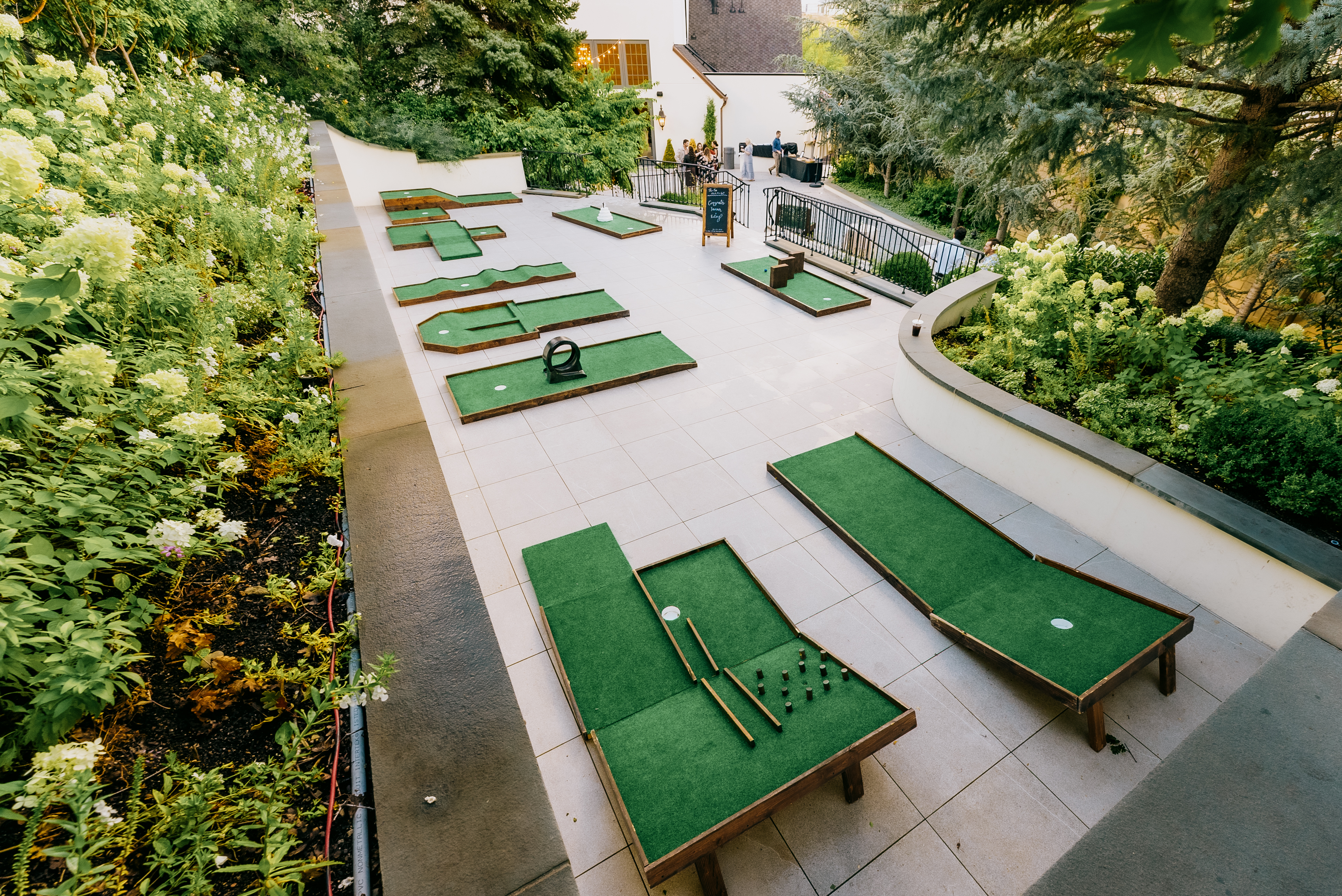 A bride and groom kiss at sunset by the water.