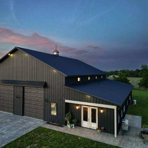 A new custom barndominium build completed in June seen in evening, for barndominium construction in olathe kansas