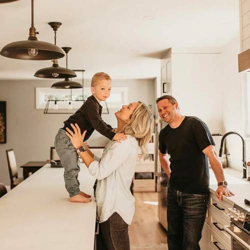 young family showing off their new modern farmhouse build, for modern farmhouse builder in olathe kansas