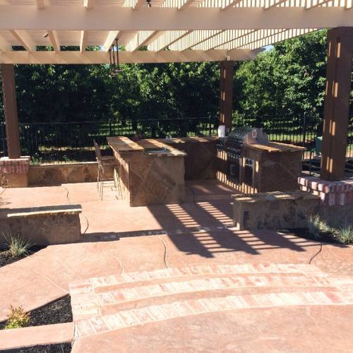 Custom patio with pergola and outdoor kitchen, for concrete patio construction in olathe ks
