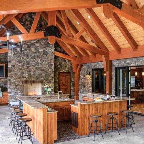 fully covered outdoor kitchen build with fireplace and large wooden beams, for outdoor kitchen pergola and builder in olathe ks