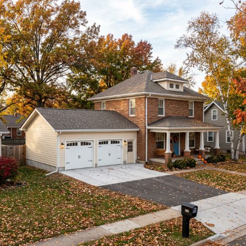 A picture in the late autumn showing a newly built attached garage that has been built only an older house in Olathe, KS