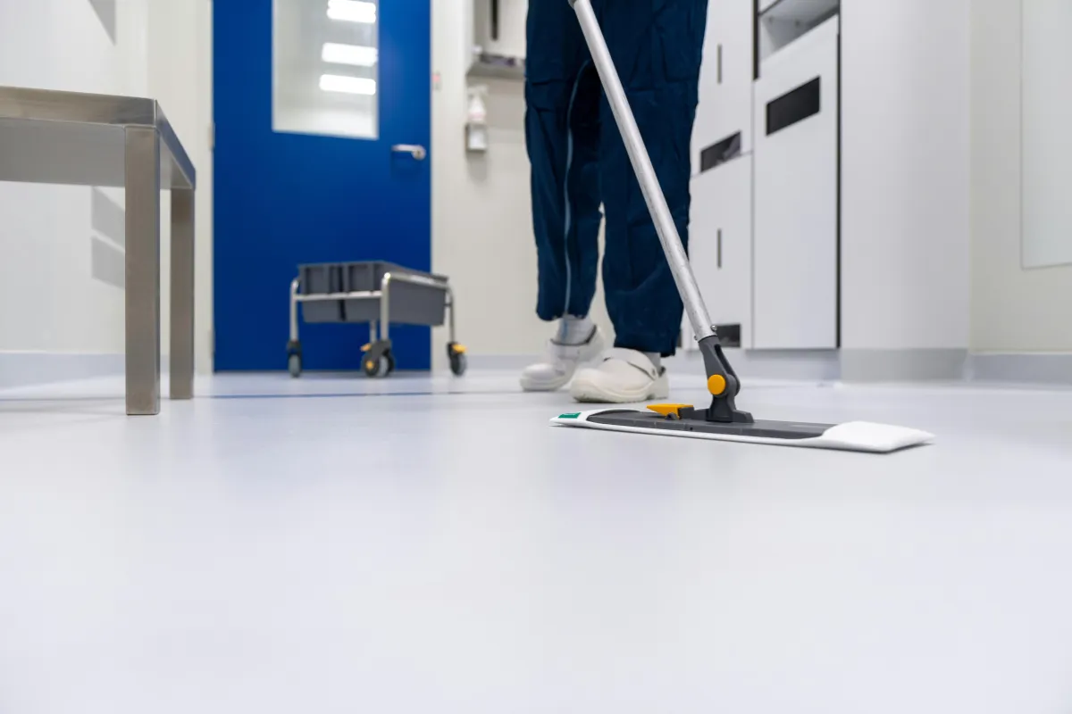 Office janitorial staff cleaning commercial workspace