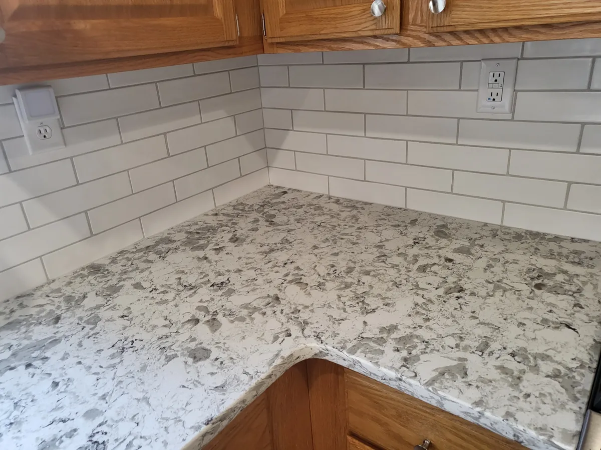 Granite kitchen countertop with white subway tile