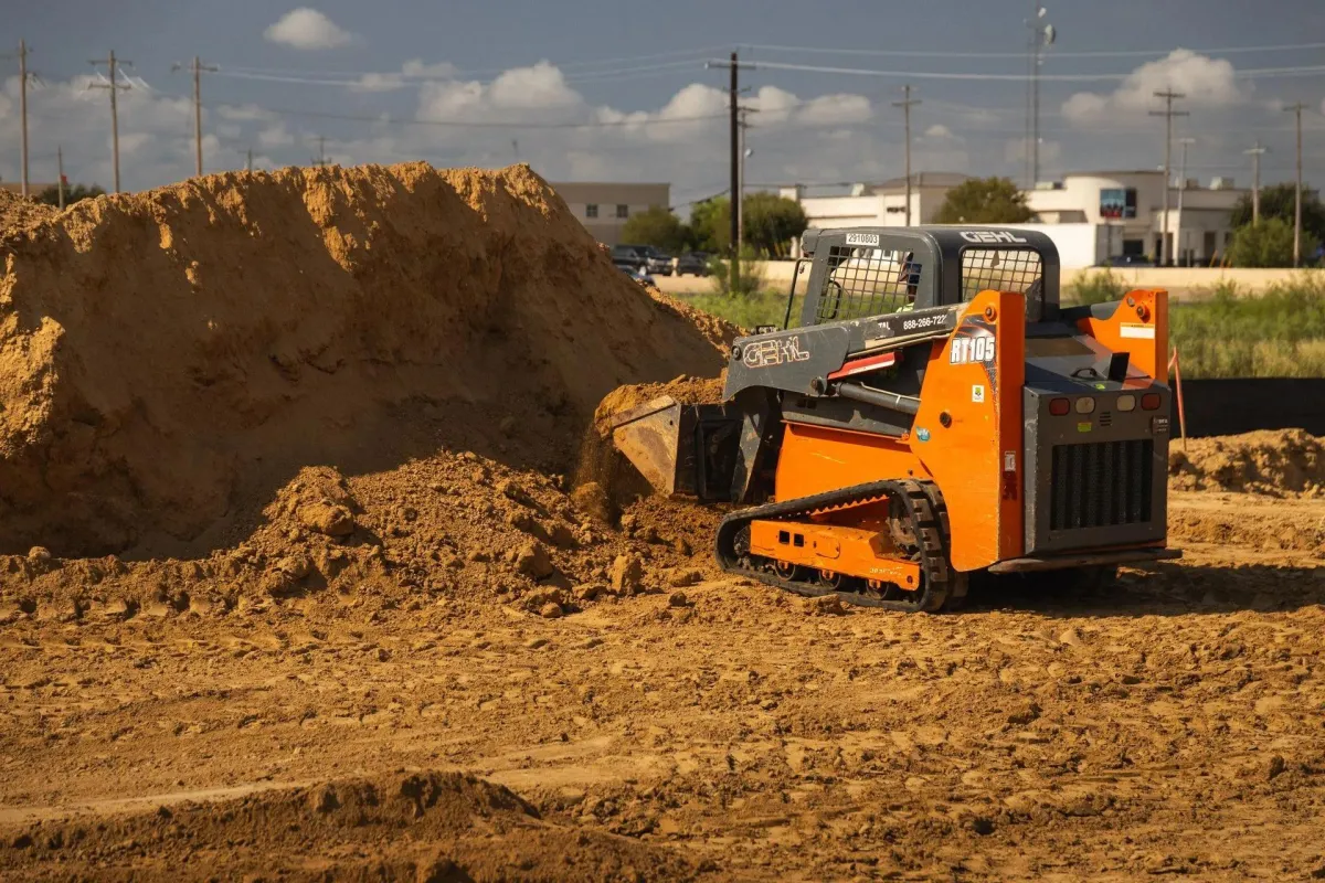 Orange small skid steer loader – ATEX Rentals Laredo