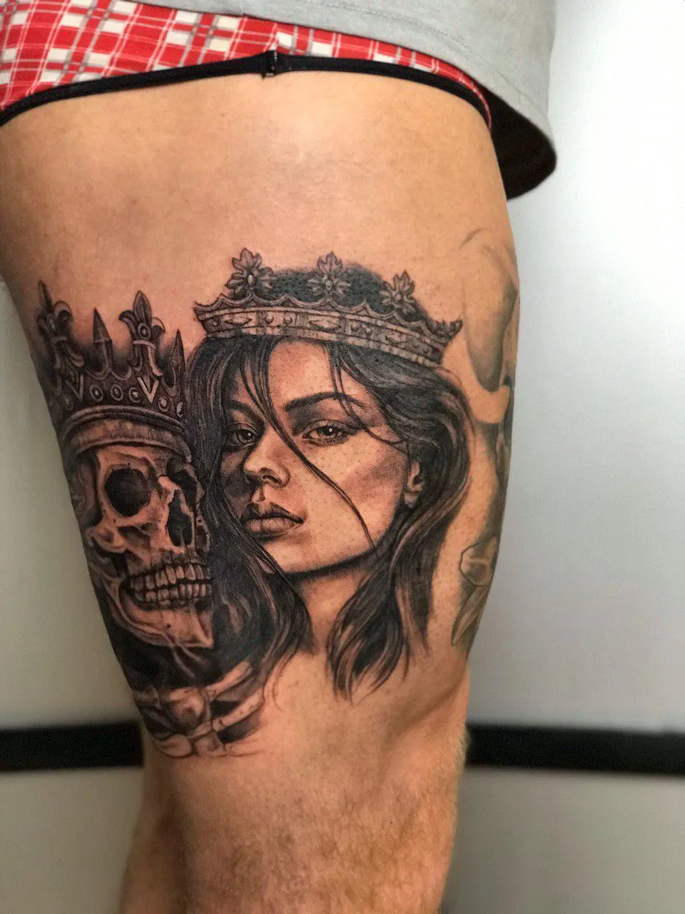 person in blue denim shorts and white nike sneakers standing on gray concrete floor