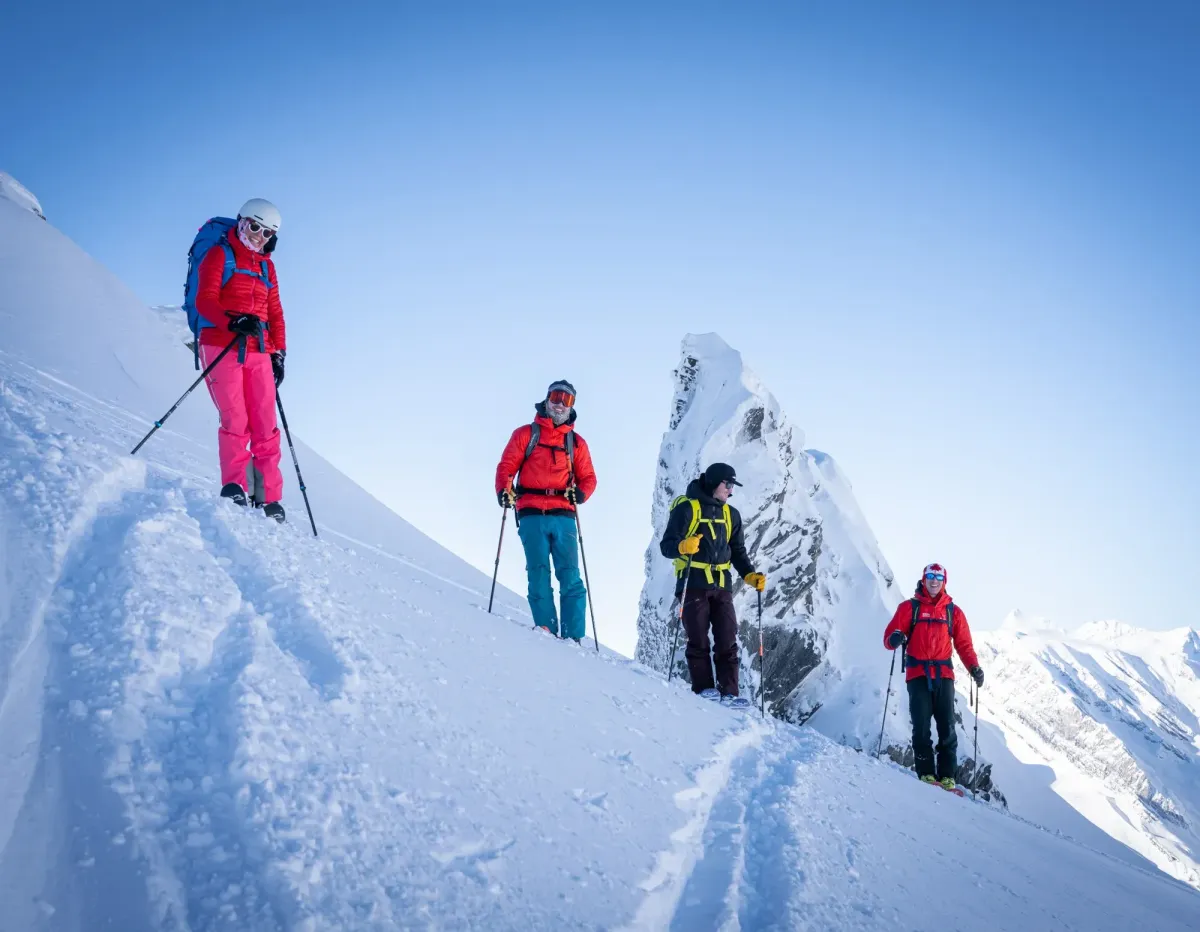 skiers climbing a couloir