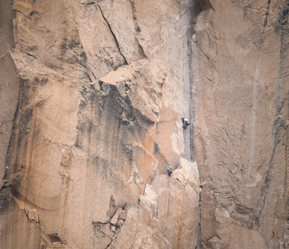 skiers climbing a couloir