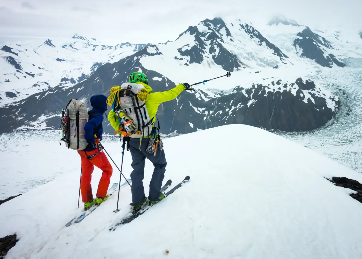 skiers climbing a couloir