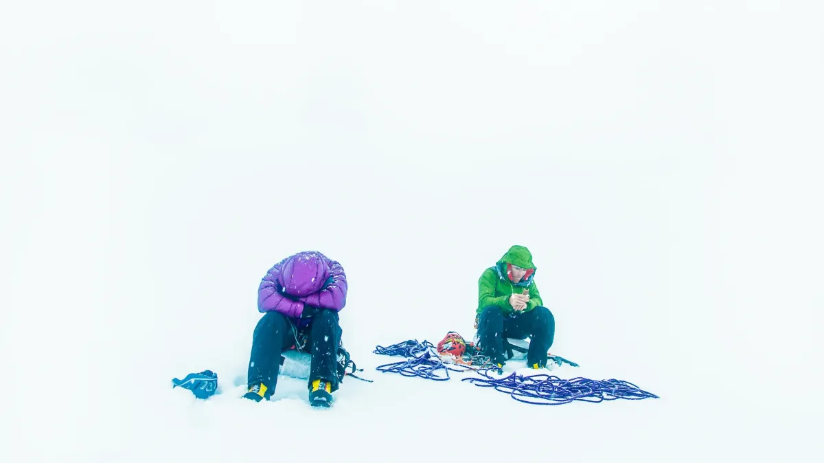 skiers climbing a couloir