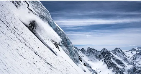 skiers climbing a couloir