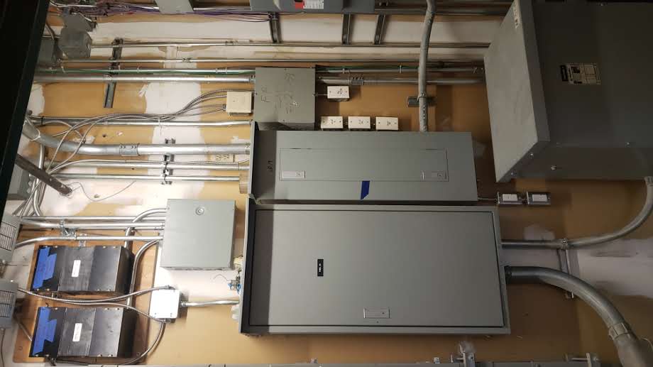 Three thin wires against a clear blue sky