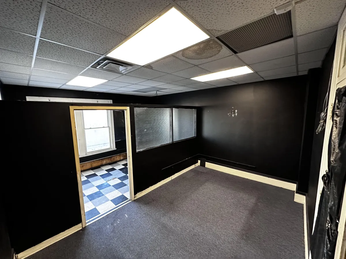 Neutral-toned office suite with divider wall and large window light