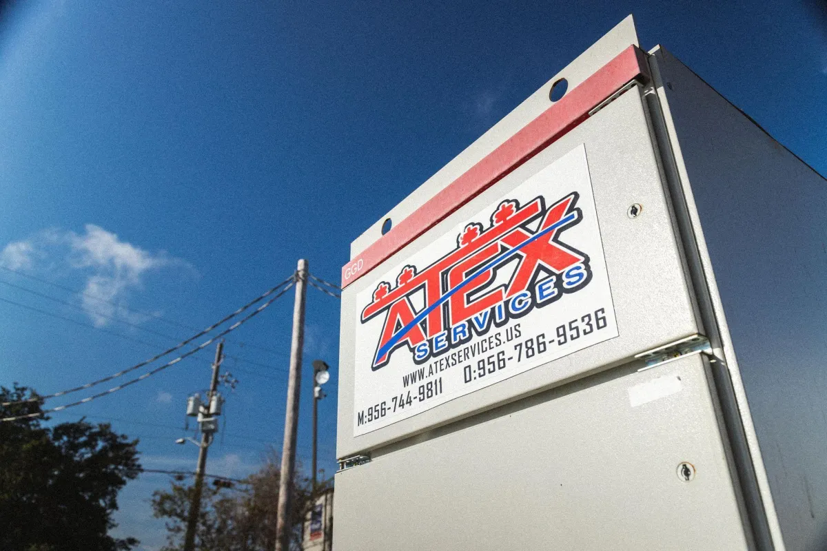 ATEX Services logo on project site equipment representing architectural design and purpose-driven construction solutions in Texas and Colorado