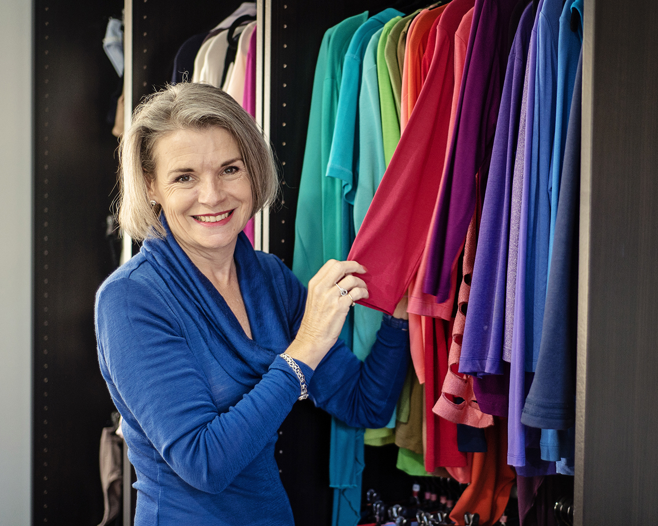 Woman in hat smoking a cigarette outdoors.