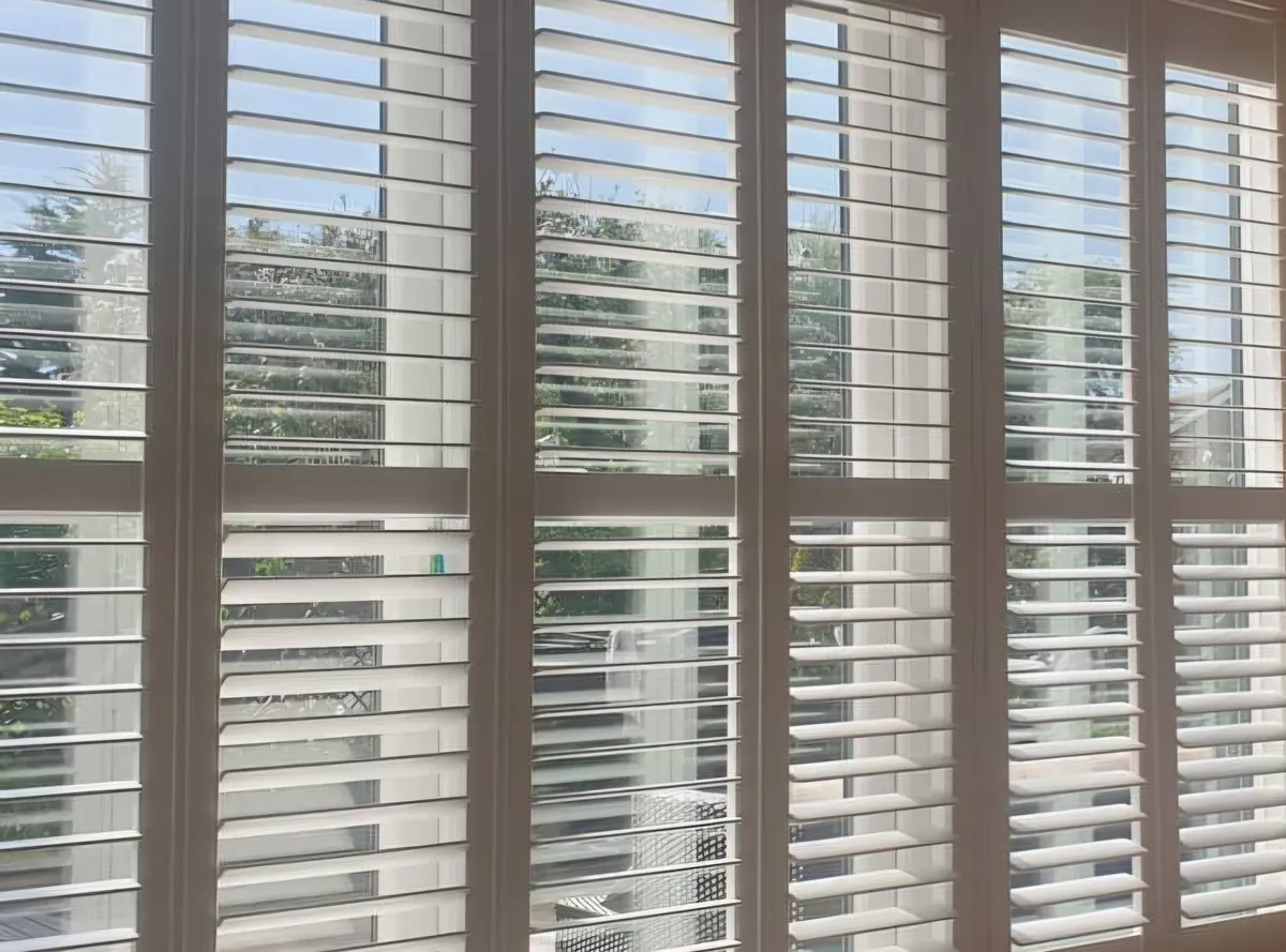 White plantation shutters fitted across a wide window by Eclipse SBC, serving Gainsborough