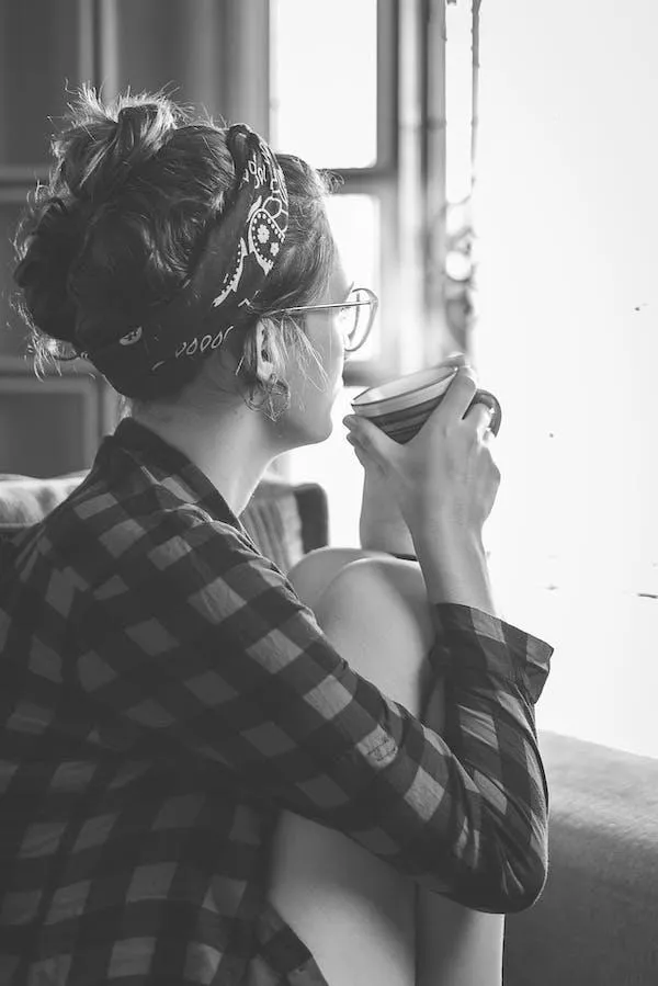 Bare branches with pink blossoms against sky