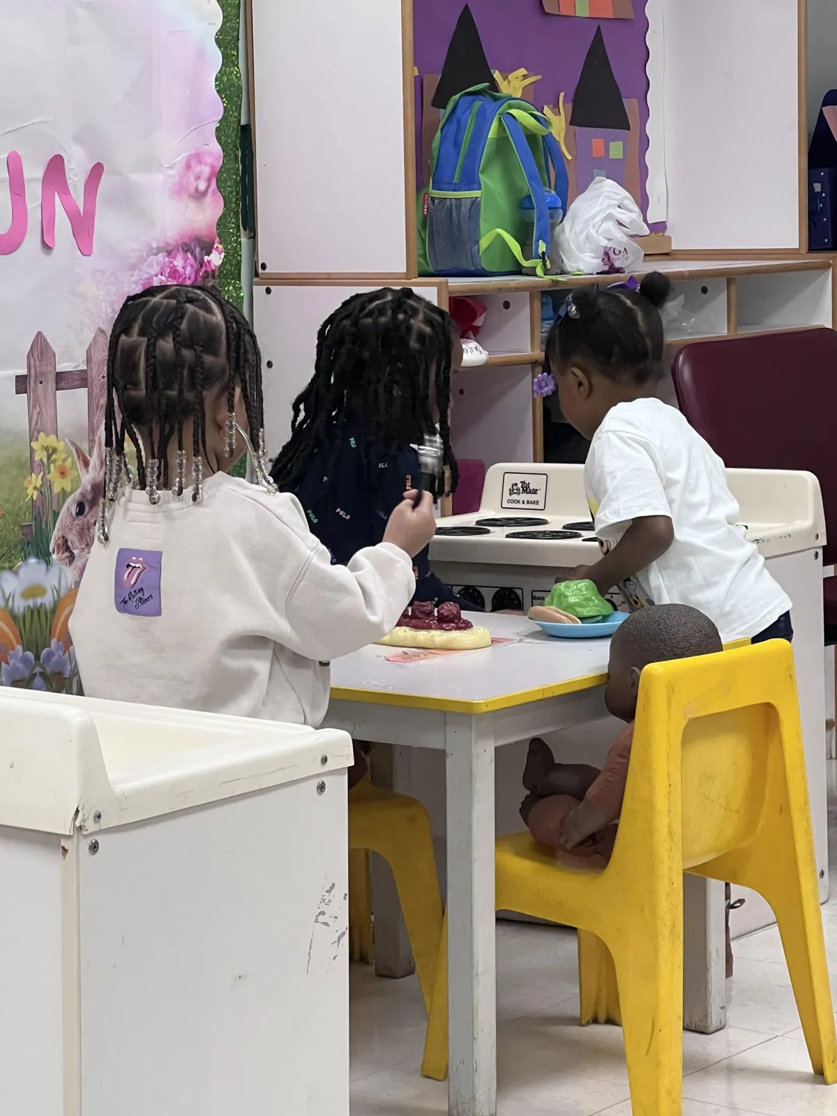Child waves at laptop