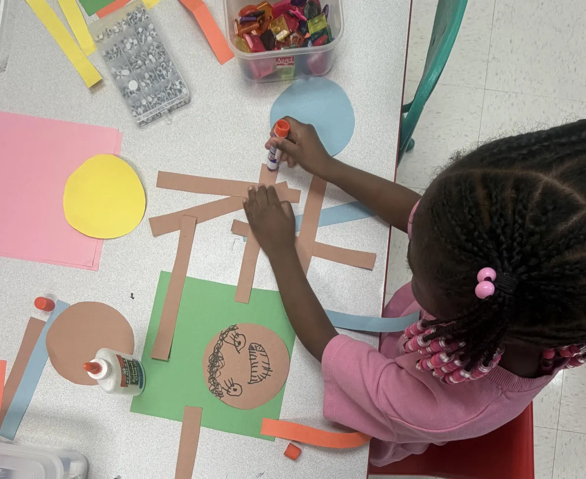 Girl follows directions during arts and crafts time.