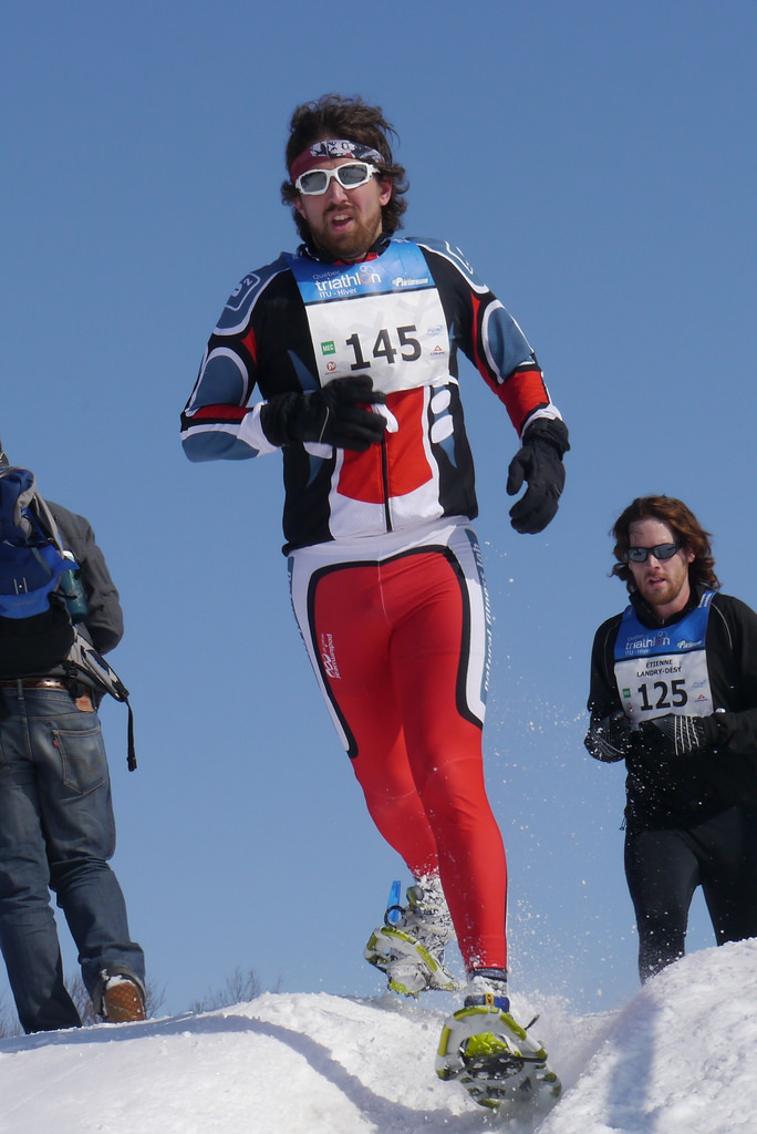 Mike Caldwell racing in a winter triathlon, showcasing endurance background behind Mad Trapper Racing