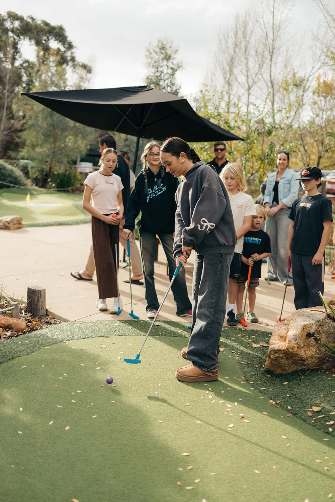 Family-friendly activities at Yallingup Maze showcasing children crossing the rock stepping stones over a picturesque water feature.