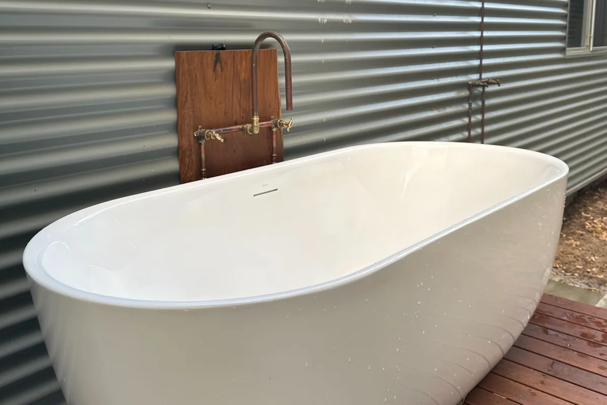 A luxury outdoor freestanding soaking tub on a timber deck, perfect for a relaxing bath under the stars in the Margaret River region.