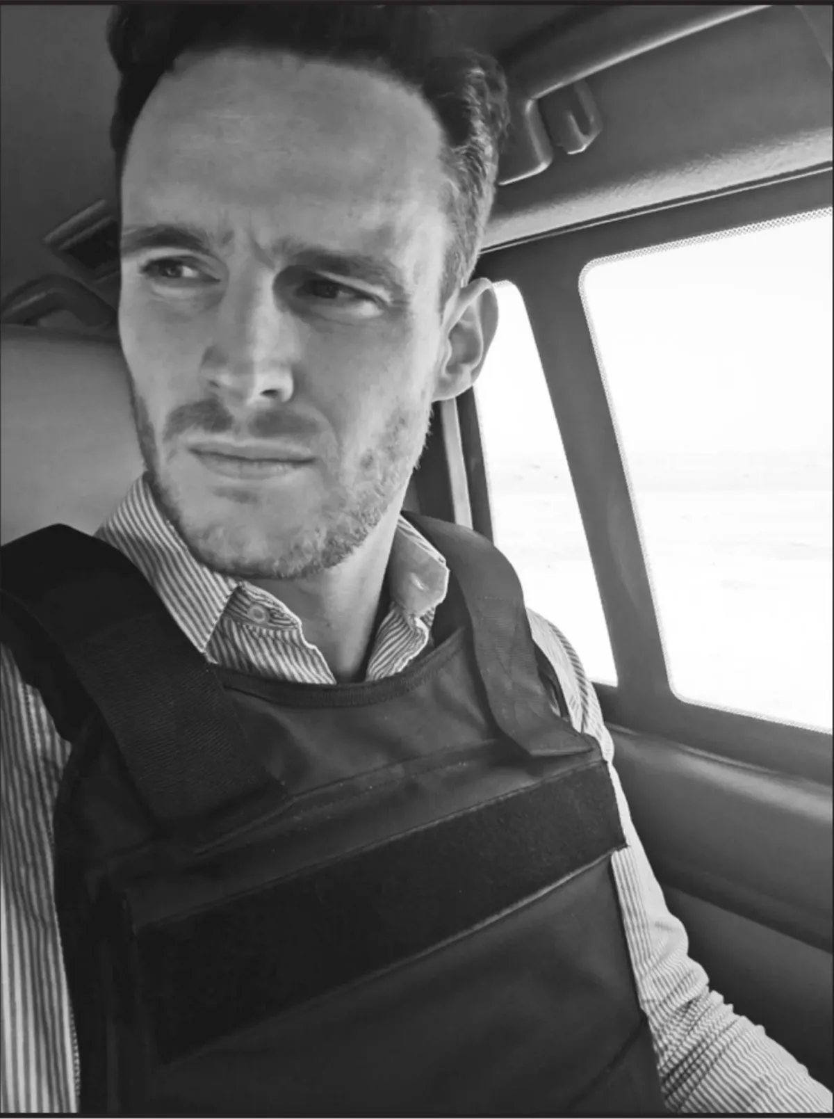 Page 11: Photo of Cian in the bulletproof vest