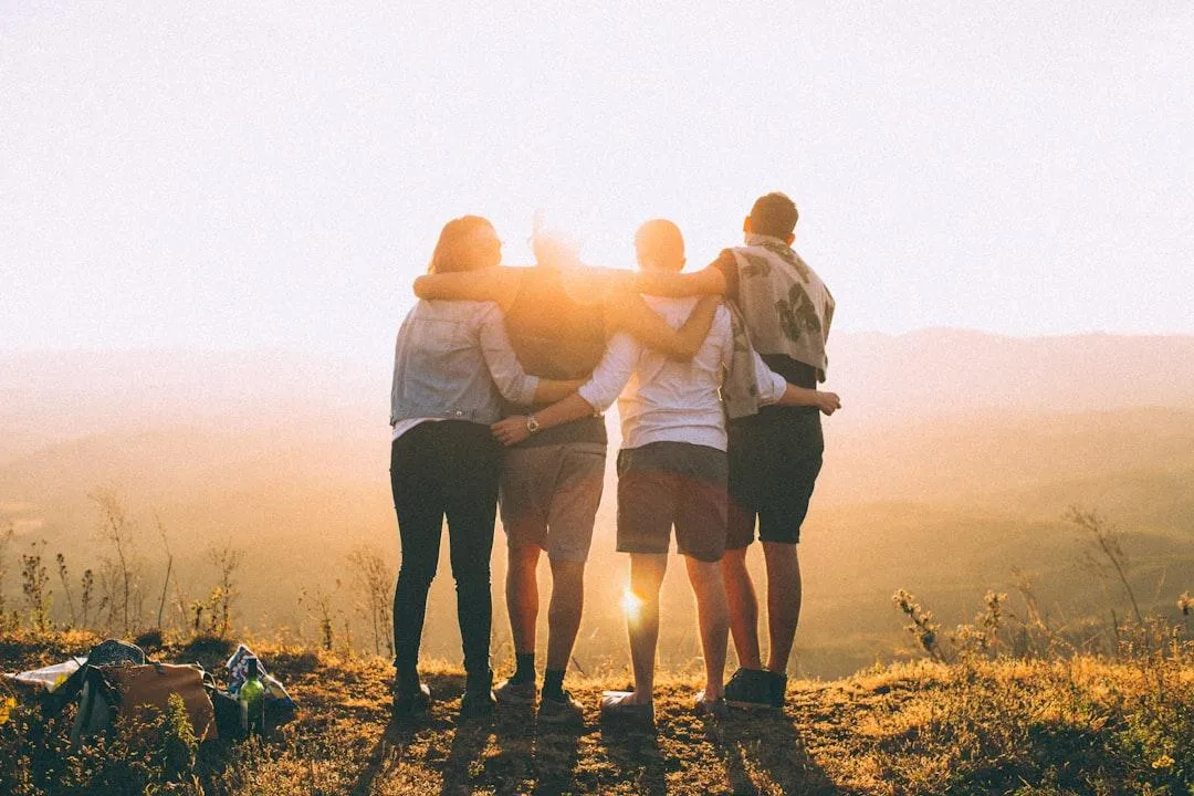 Group standing on top of a hill enjoying life