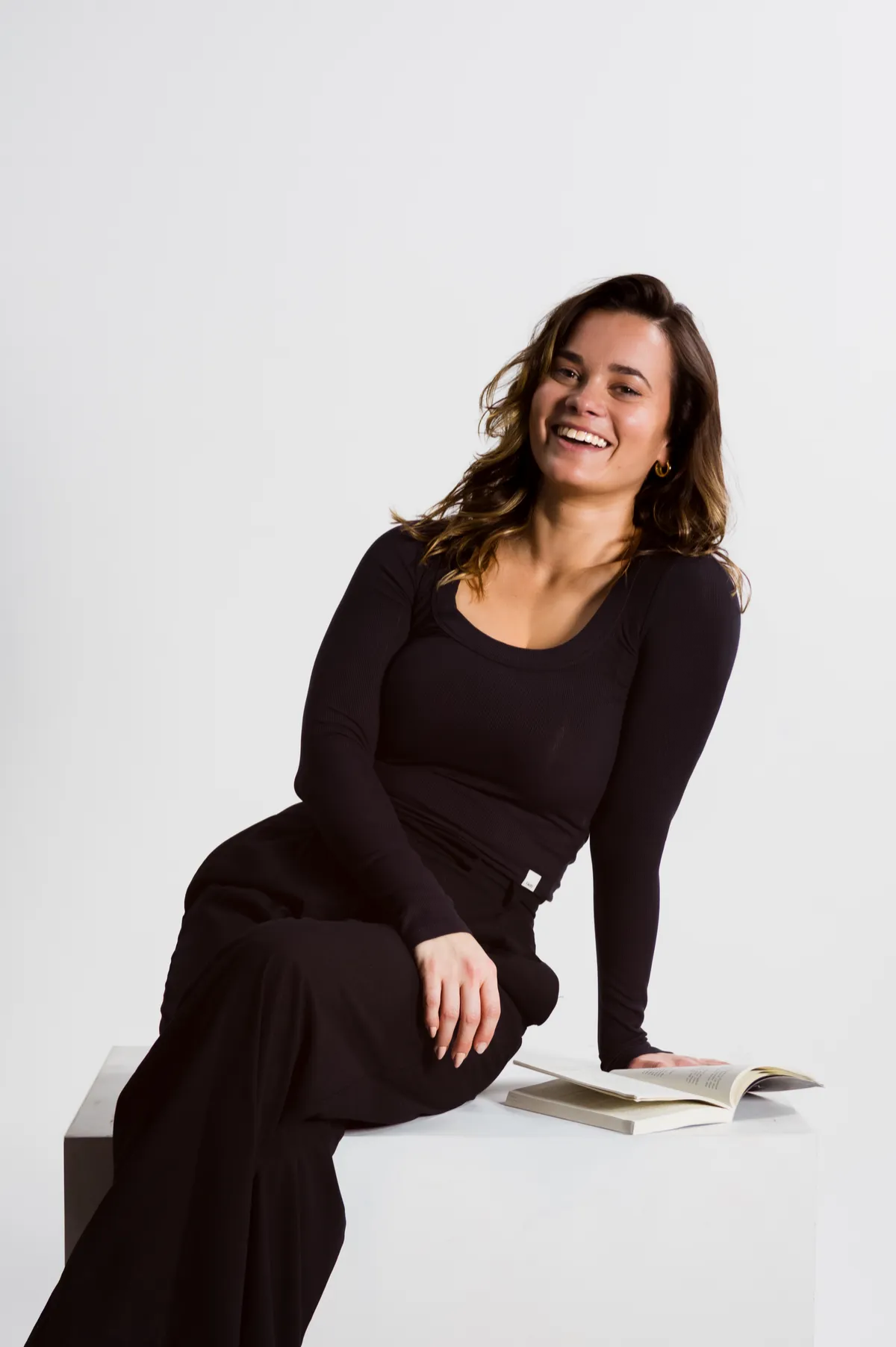 Warm and grounded portrait of coach Azul in naturally lit studio
