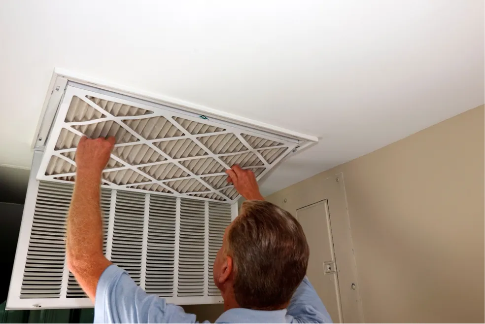 Professional HVAC technician servicing an air conditioning unit