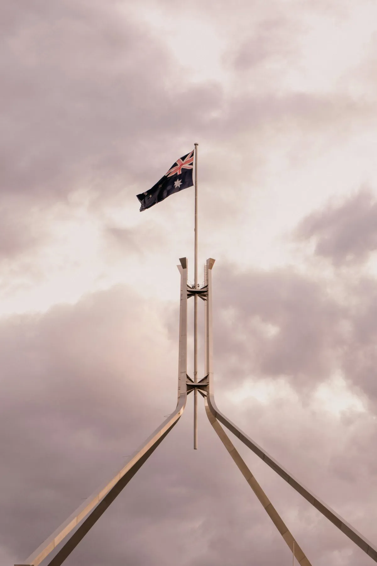 The iconic flag atop parliament house in Canberra, one of the cities Aus Biz AI s provides AI automation services to.