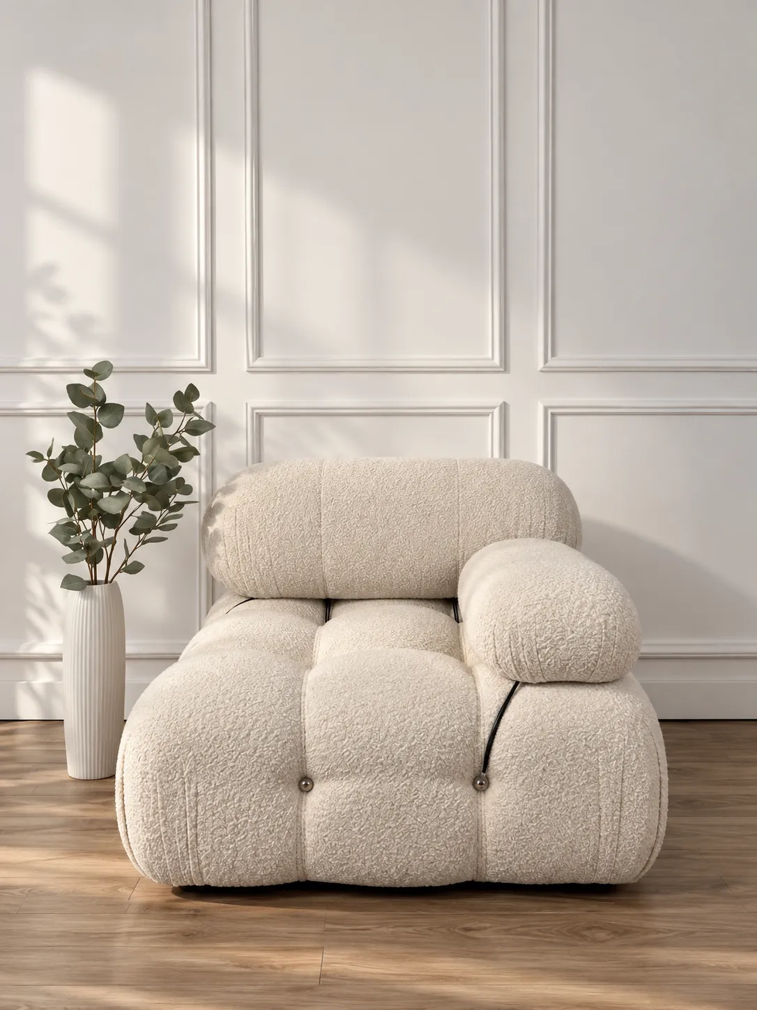 Photo of Bauhaus inspired sofa on white background with eucalyptus in vase